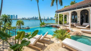 Infinity-edge freeform pool with raised spa overlooking a bay and city skyline.