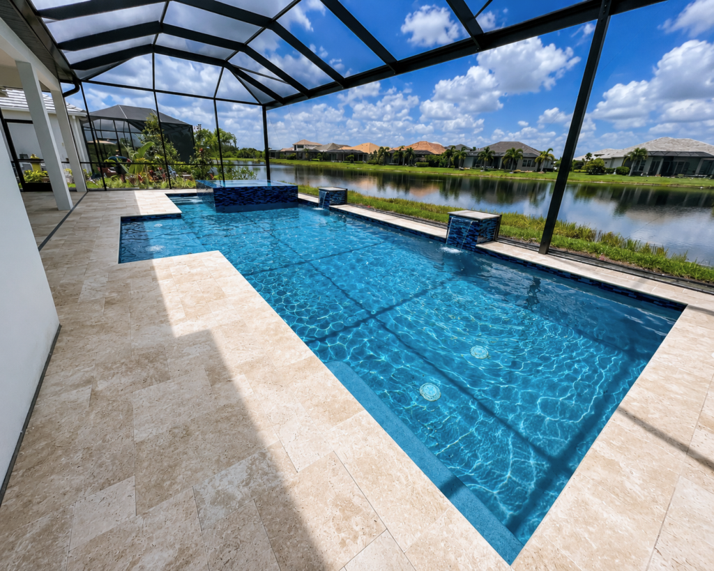 L-shaped pool with raised spa and water bowl fountains under a screened enclosure overlooking a lake.