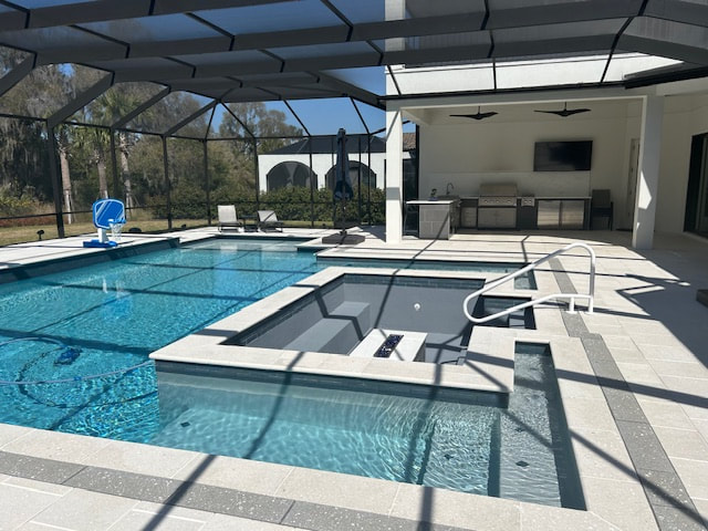 A screened backyard pool with an attached raised spa and an outdoor kitchen under a covered lanai.